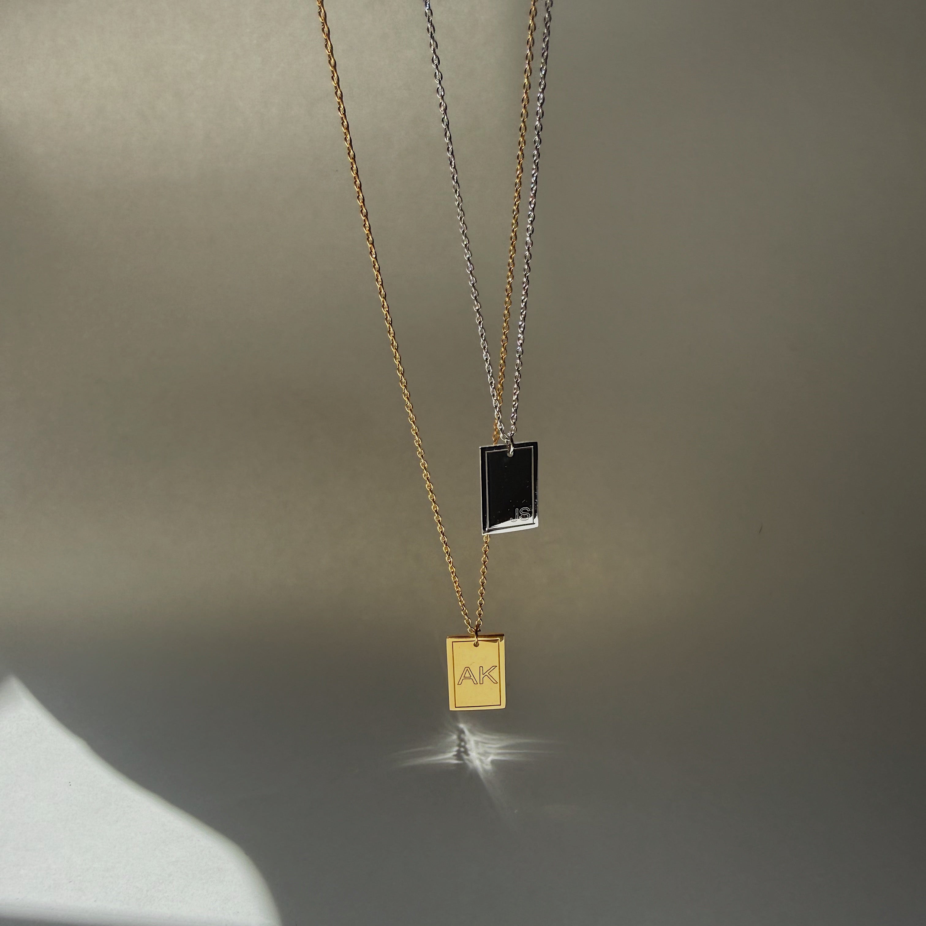 Gold necklace with a pendant on a gray background